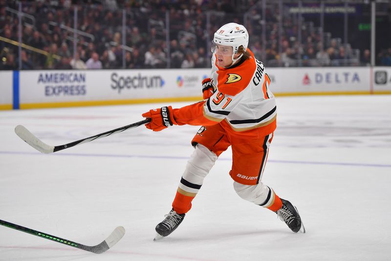 Apr 10, 2025; Los Angeles, California, USA; Anaheim Ducks center Leo Carlsson (91) shoots on goal against the Los Angeles Kings during the first period at Crypto.com Arena. Mandatory Credit: Gary A. Vasquez-Imagn Images