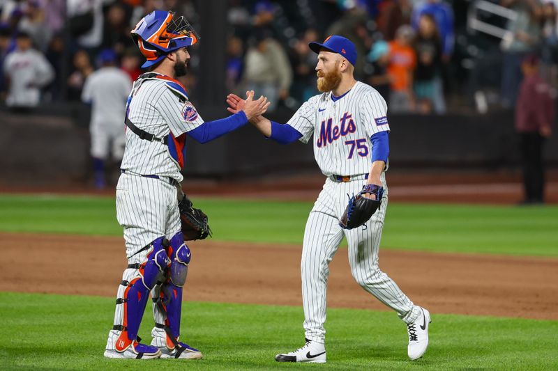 May 30, 2024; New York City, New York, USA; New York Mets catcher Tomás Nido (3) and relief pitcher Reed Garrett (75) celebrate after defeating the Arizona Diamondbacks 3-2 at Citi Field. Mandatory Credit: Wendell Cruz-USA TODAY Sports