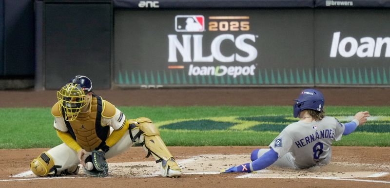 Oct 14, 2025; Milwaukee, Wisconsin, USA; Los Angeles Dodgers left fielder Enrique Hernandez (8) slides safely into home plate against Milwaukee Brewers catcher William Contreras (24) in the second inning during game two of the NLCS round for the 2025 MLB playoffs at American Family Field. Mandatory Credit: Mark Hoffman-USA TODAY Network via Imagn Images