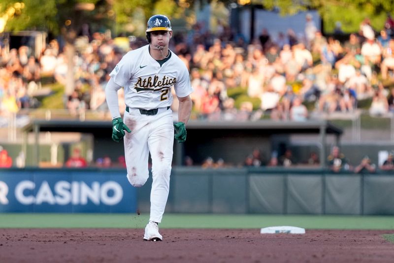 May 21, 2025; West Sacramento, California, USA; Athletics left fielder Tyler Soderstrom (21) advances to third base on a throwing error by the Los Angeles Angels in the second inning at Sutter Health Park. Mandatory Credit: Cary Edmondson-Imagn Images