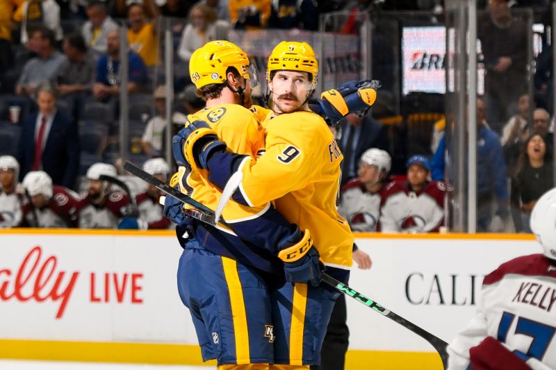 Nov 2, 2024; Nashville, Tennessee, USA;  Nashville Predators defenseman Roman Josi (59) celebrates his goal with left wing Filip Forsberg (9) against the Colorado Avalanche during the third period at Bridgestone Arena. Mandatory Credit: Steve Roberts-Imagn Images