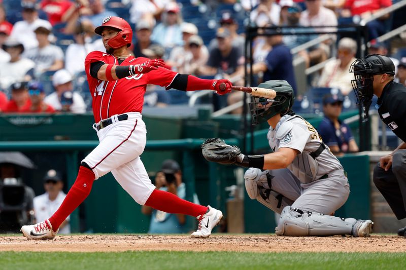 Aug 13, 2023; Washington, District of Columbia, USA; Washington Nationals shortstop Ildemaro Vargas (14) hits a single against the Oakland Athletics during the third inning at Nationals Park. Mandatory Credit: Geoff Burke-USA TODAY Sports