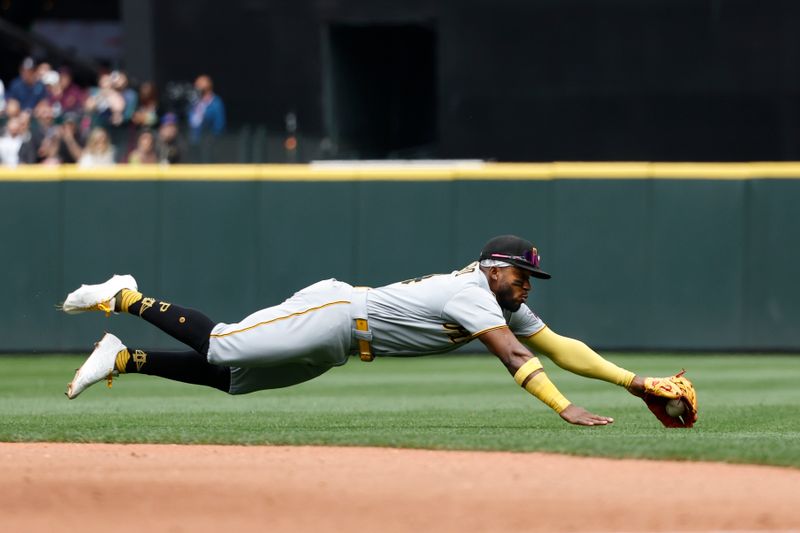 May 28, 2023; Seattle, Washington, USA; Pittsburgh Pirates second baseman Rodolfo Castro (14) fields an infield single against the Seattle Mariners during the third inning at T-Mobile Park. Mandatory Credit: Joe Nicholson-USA TODAY Sports