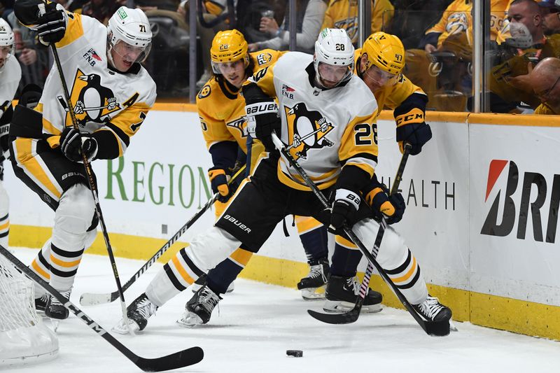 Nov 28, 2023; Nashville, Tennessee, USA; Pittsburgh Penguins defenseman Marcus Pettersson (28) and center Evgeni Malkin (71) work for the puck against Nashville Predators right wing Michael McCarron (47) and center Philip Tomasino (26) during the first period at Bridgestone Arena. Mandatory Credit: Christopher Hanewinckel-USA TODAY Sports