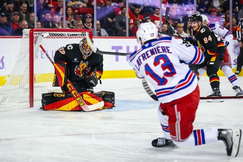 Nov 21, 2024; Calgary, Alberta, CAN; Calgary Flames goaltender Dustin Wolf (32) makes a save against New York Rangers left wing Alexis Lafrenière (13) during the first period at Scotiabank Saddledome. Mandatory Credit: Sergei Belski-Imagn Images