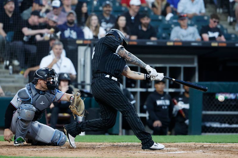 Jun 9, 2023; Chicago, Illinois, USA; Chicago White Sox catcher Yasmani Grandal (24) singles against the Miami Marlins during the fourth inning at Guaranteed Rate Field. Mandatory Credit: Kamil Krzaczynski-USA TODAY Sports