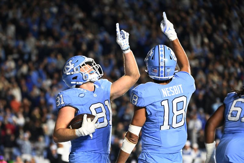 Nov 11, 2023; Chapel Hill, North Carolina, USA; North Carolina Tar Heels tight end John Copenhaver (81) celebrates with tight end Bryson Nesbit (18) after catching a two point conversion in the second overtime at Kenan Memorial Stadium. Mandatory Credit: Bob Donnan-USA TODAY Sports