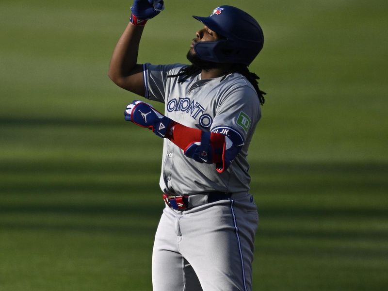 Apr 20, 2024; San Diego, California, USA; Toronto Blue Jays first baseman Vladimir Guerrero Jr. (27) celebrates after hitting a double during the first inning against the San Diego Padres at Petco Park. Mandatory Credit: Orlando Ramirez-USA TODAY Sports