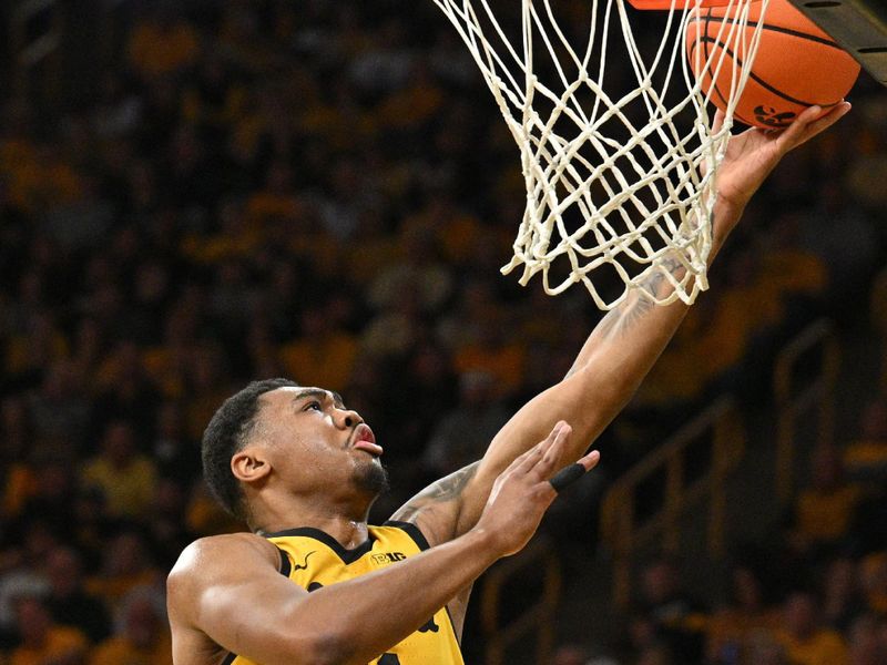 Feb 25, 2023; Iowa City, Iowa, USA; Iowa Hawkeyes guard Tony Perkins (11) goes to the basket against the Michigan State Spartans during the second half at Carver-Hawkeye Arena. Mandatory Credit: Jeffrey Becker-USA TODAY Sports