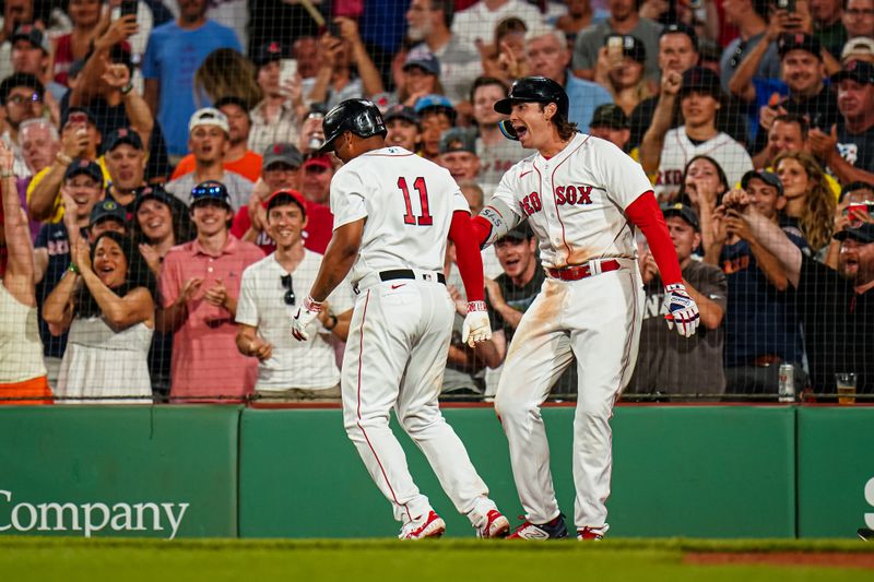 Jul 23, 2023; Boston, Massachusetts, USA; Boston Red Sox third baseman Rafael Devers (11) is congratulated by first baseman Triston Casas (36) after hitting a home run against the New York Mets in the seventh inning at Fenway Park. Mandatory Credit: David Butler II-USA TODAY Sports