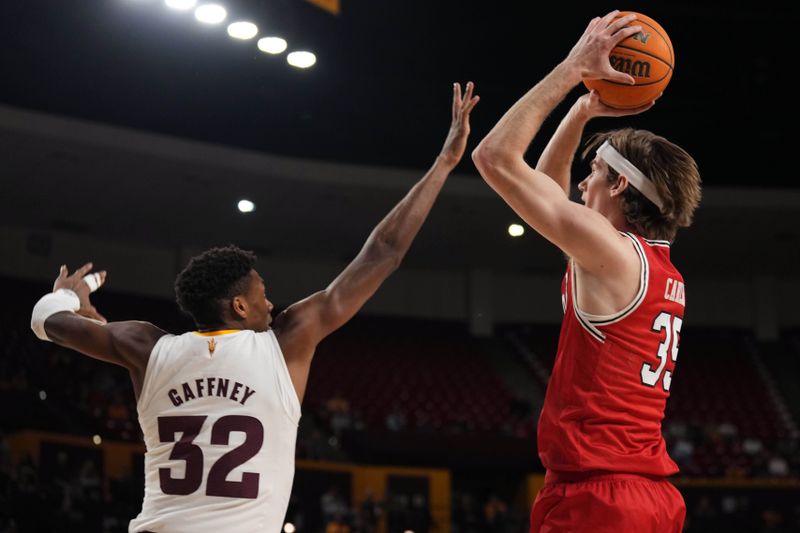 Feb 18, 2023; Tempe, Arizona, USA; Utah Utes center Branden Carlson (35) shoots over Arizona State Sun Devils forward Alonzo Gaffney (32) during the first half at Desert Financial Arena. Mandatory Credit: Joe Camporeale-USA TODAY Sports