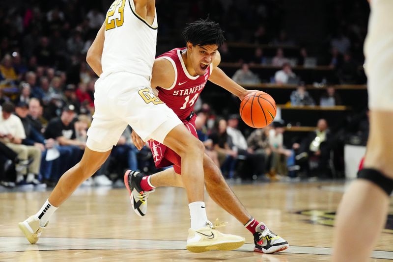 Feb 5, 2023; Boulder, Colorado, USA; Stanford Cardinal forward Spencer Jones (14) dribbles at Colorado Buffaloes forward Tristan da Silva (23) in the second half at the CU Events Center. Mandatory Credit: Ron Chenoy-USA TODAY Sports