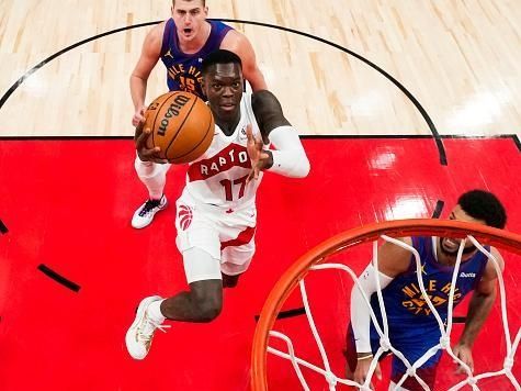 TORONTO, ON - DECEMBER 20: Dennis Schroder #17 of the Toronto Raptors goes to the basket against Nikola Jokic #15 and Jamal Murray #27 of the Denver Nuggets during the first half  at Scotiabank Arena on December 20, 2023 in Toronto, Ontario, Canada. NOTE TO USER: User expressly acknowledges and agrees that, by downloading and/or using this Photograph, user is consenting to the terms and conditions of the Getty Images License Agreement. (Photo by Andrew Lahodynskyj/Getty Images)