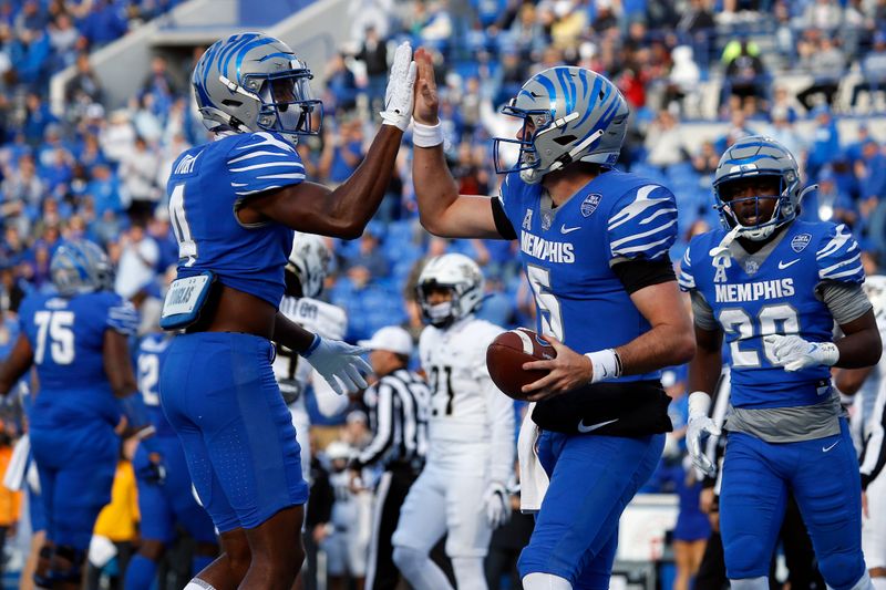 Nov 5, 2022; Memphis, Tennessee, USA; Memphis Tigers quarterback Seth Henigan (right) reacts with Memphis Tigers wide receiver Javon Ivory (4) after a touchdown during the first half against the UCF Knights at Liberty Bowl Memorial Stadium. Mandatory Credit: Petre Thomas-USA TODAY Sports