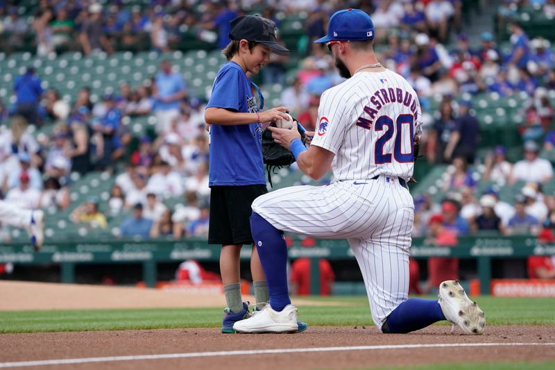 Jul 7, 2024; Chicago, Illinois, USA; Chicago Cubs third baseman Miles Mastrobuoni (20) signs an autograph before the game against the Los Angeles Angels at Wrigley Field. Mandatory Credit: David Banks-USA TODAY Sports