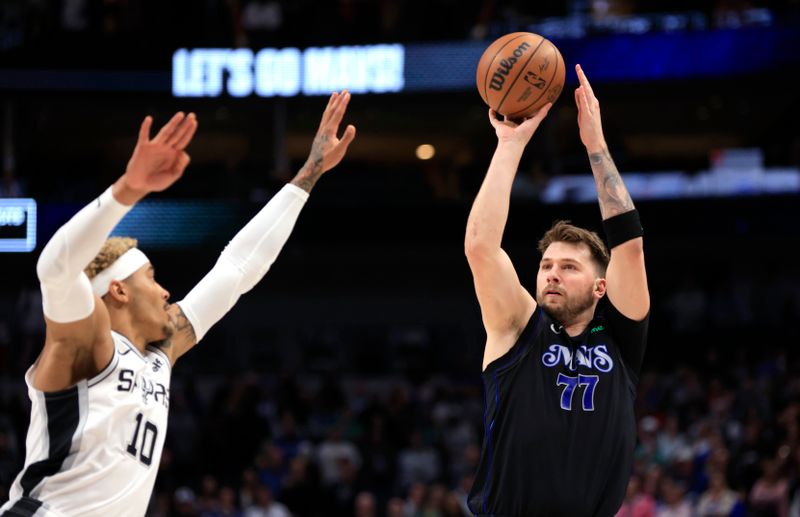 DALLAS, TX - FEBRUARY 14: Luka Doncic #77 of the Dallas Mavericks shoots ball over Jeremy Sochan #10 of the San Antonio Spurs in the first half at American Airlines Center on February 14, 2024 in Dallas, Texas. NOTE TO USER: User expressly acknowledges and agrees that, by downloading and or using this photograph, User is consenting to the terms and conditions of the Getty Images License Agreement. (Photo by Ron Jenkins/Getty Images)