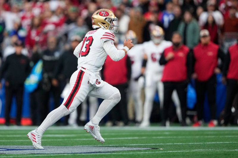 San Francisco 49ers quarterback Brock Purdy (13) nuns during the first half of an NFL football game against the Seattle Seahawks, Thursday, Oct. 10, 2024, in Seattle. (AP Photo/Lindsey Wasson)