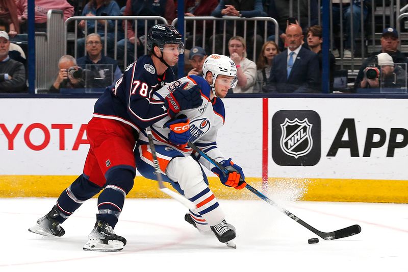 Oct 28, 2024; Columbus, Ohio, USA; Edmonton Oilers right wing Vasily Podkolzin (92) carries the puck as Columbus Blue Jackets defenseman Damon Severson (78) defends during the first period at Nationwide Arena. Mandatory Credit: Russell LaBounty-Imagn Images