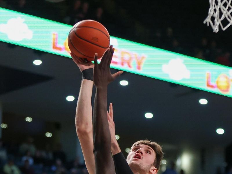 Feb 6, 2024; Atlanta, Georgia, USA; Wake Forest Demon Deacons forward Andrew Carr (11) shoots over Georgia Tech Yellow Jackets forward Baye Ndongo (11) in the first half at McCamish Pavilion. Mandatory Credit: Brett Davis-USA TODAY Sports