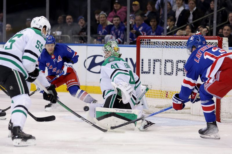 Feb 20, 2024; New York, New York, USA; Dallas Stars goaltender Scott Wedgewood (41) makes a save against New York Rangers left wing Alexis Lafreniere (13) and left wing Artemi Panarin (10) during the first period at Madison Square Garden. Mandatory Credit: Brad Penner-USA TODAY Sports