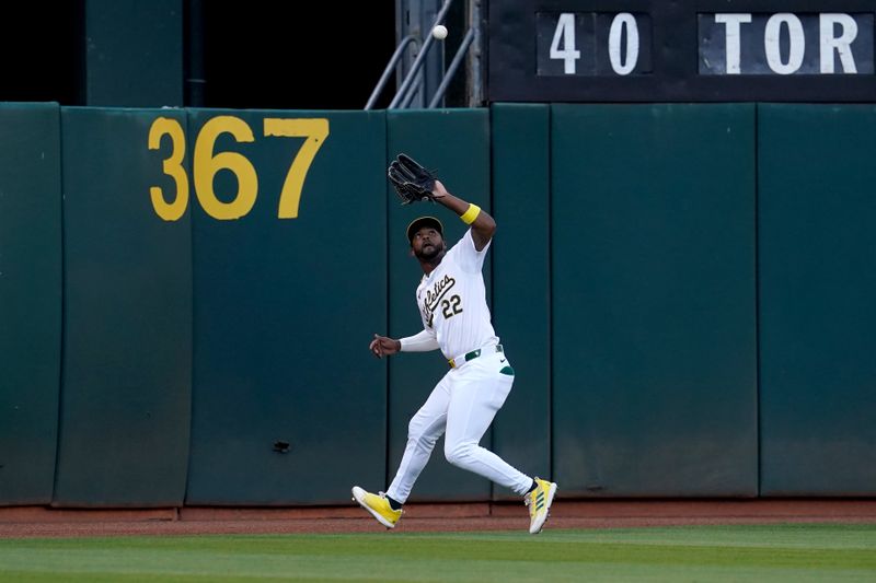 Jul 19, 2024; Oakland, California, USA; Oakland Athletics left fielder Miguel Andujar (22) makes a catch near the warning track against the Los Angeles Angels in the second inning at Oakland-Alameda County Coliseum. Mandatory Credit: Cary Edmondson-USA TODAY Sports