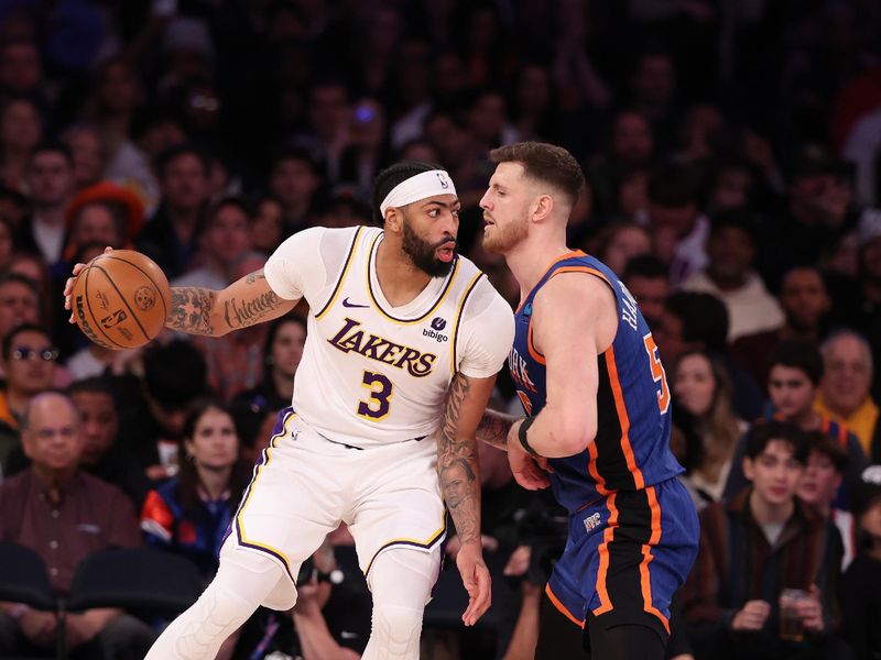 NEW YORK, NEW YORK - FEBRUARY 03:  Anthony Davis #3 of the Los Angeles Lakers drives against Isaiah Hartenstein #55 of the New York Knicks during their game at Madison Square Garden on February 03, 2024 in New York City.   User expressly acknowledges and agrees that, by downloading and or using this photograph, User is consenting to the terms and conditions of the Getty Images License Agreement.  (Photo by Al Bello/Getty Images)