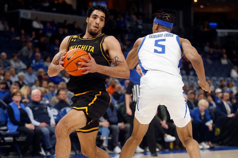 Jan 19, 2023; Memphis, Tennessee, USA; Wichita State Shockers forward James Rojas (33) spins toward the basket as Memphis Tigers forward Kaodirichi Akobundu-Ehiogu (5) defends during the first half at FedExForum. Mandatory Credit: Petre Thomas-USA TODAY Sports
