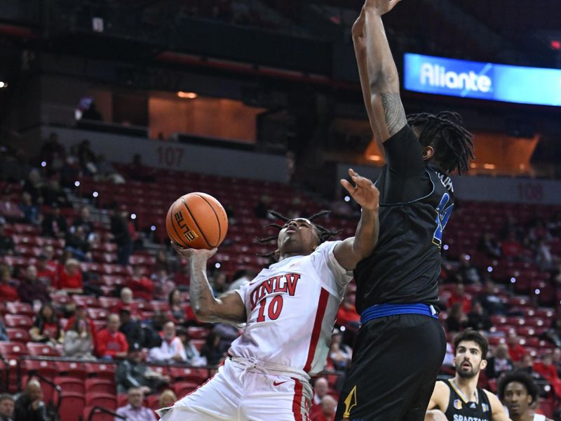 Feb 14, 2023; Las Vegas, Nevada, USA; UNLV Runnin' Rebels guard Keshon Gilbert (10) drives on net against San Jose State Spartans forward Robert Vaihola (22) in the first half at Thomas & Mack Center. Mandatory Credit: Candice Ward-USA TODAY Sports