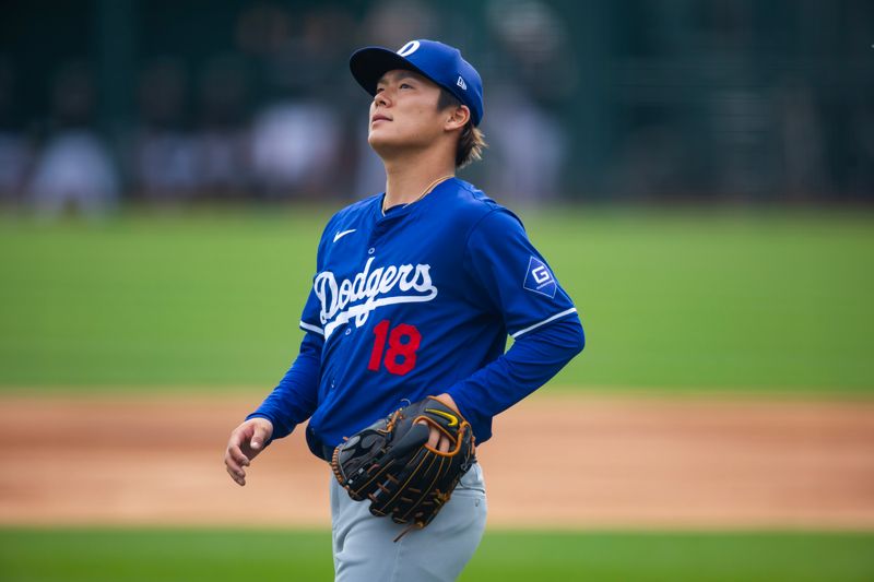 Mar 6, 2024; Phoenix, Arizona, USA; Los Angeles Dodgers pitcher Yoshinobu Yamamoto reacts against the Chicago White Sox during a spring training baseball game at Camelback Ranch-Glendale. Mandatory Credit: Mark J. Rebilas-USA TODAY Sports