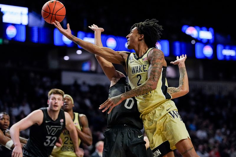 Jan 3, 2026; Winston-Salem, North Carolina, USA; Wake Forest Demon Deacons guard Juke Harris (2) with a lay up defended by Virginia Tech Hokies guard Jailen Bedford (0) during the first half at Lawrence Joel Veterans Memorial Coliseum. Mandatory Credit: Jim Dedmon-Imagn Images