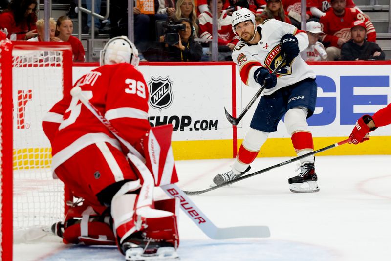 Oct 15, 2025; Detroit, Michigan, USA;  Florida Panthers center Sam Reinhart (13) takes a shot in the first period against the Detroit Red Wings at Little Caesars Arena. Mandatory Credit: Rick Osentoski-Imagn Images