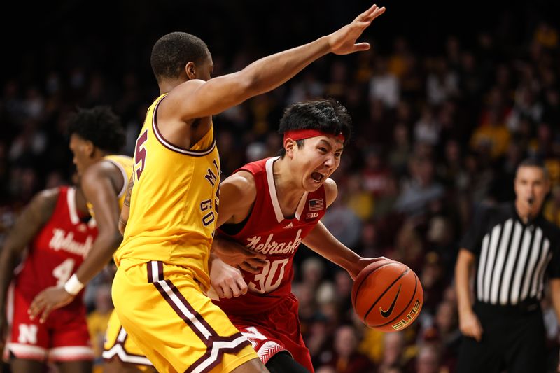 Jan 7, 2023; Minneapolis, Minnesota, USA; Nebraska Cornhuskers guard Keisei Tominaga (30) drives to the basket while Minnesota Golden Gophers guard Ta'lon Cooper (55) defends during the second half at Williams Arena. Mandatory Credit: Matt Krohn-USA TODAY Sports