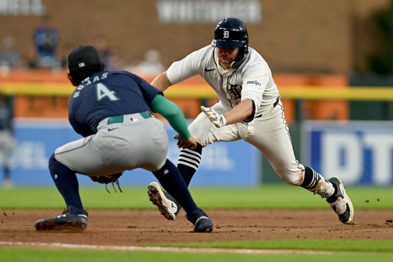 Aug 13, 2024; Detroit, Michigan, USA;  Detroit Tigers catcher Jake Rogers (34) is tagged out at third base trying to stretch a double into a triple by Seattle Mariners third baseman Josh Rojas (4) in the sixth inning at Comerica Park. Mandatory Credit: Lon Horwedel-USA TODAY Sports