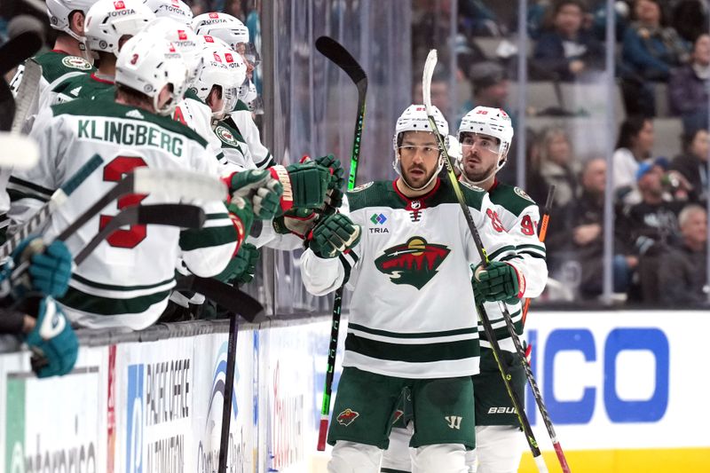 Mar 11, 2023; San Jose, California, USA; Minnesota Wild center Frederick Gaudreau (center) celebrates with teammates after scoring a goal against the San Jose Sharks during the second period at SAP Center at San Jose. Mandatory Credit: Darren Yamashita-USA TODAY Sports