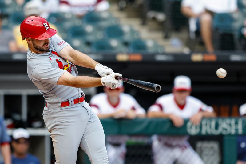 Jul 9, 2023; Chicago, Illinois, USA; St. Louis Cardinals shortstop Paul DeJong (11) hits a RBI-double against the Chicago White Sox during the tenth inning at Guaranteed Rate Field. Mandatory Credit: Kamil Krzaczynski-USA TODAY Sports