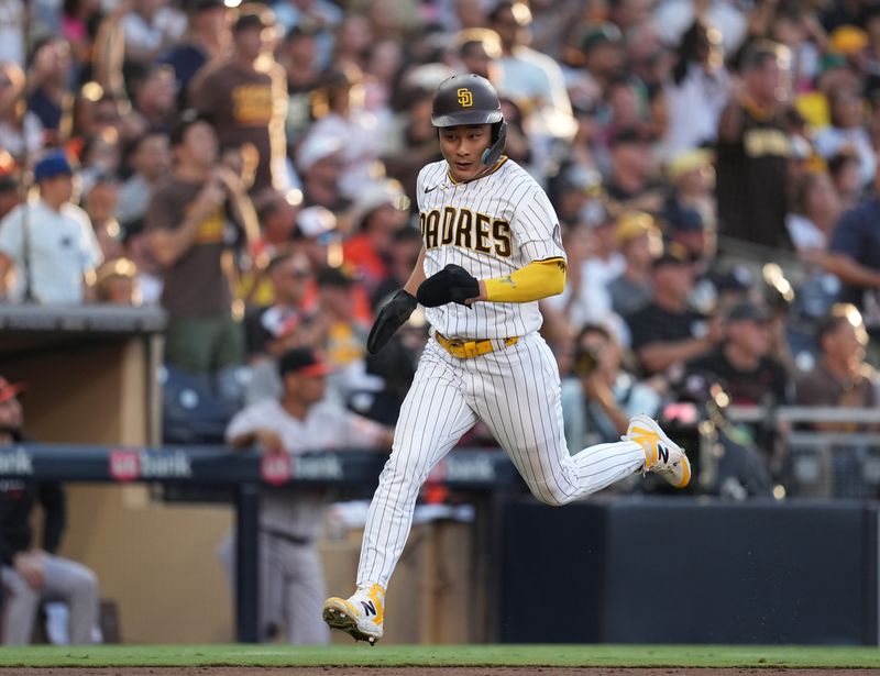 Aug 16, 2023; San Diego, California, USA; San Diego Padres second baseman Ha-Seong Kim (7) scores on  an RBI single by shortstop Xander Bogaerts (not pictured) during the third inning against the Baltimore Orioles at Petco Park. Mandatory Credit: Ray Acevedo-USA TODAY Sports