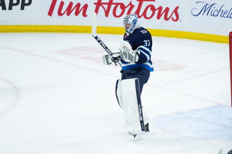 Jan 9, 2024; Winnipeg, Manitoba, CAN; Winnipeg Jets goalie Connor Hellebuyck (37) celebrates the win against the Columbus Blue Jackets at the end of the third period at Canada Life Centre. Mandatory Credit: Terrence Lee-USA TODAY Sports