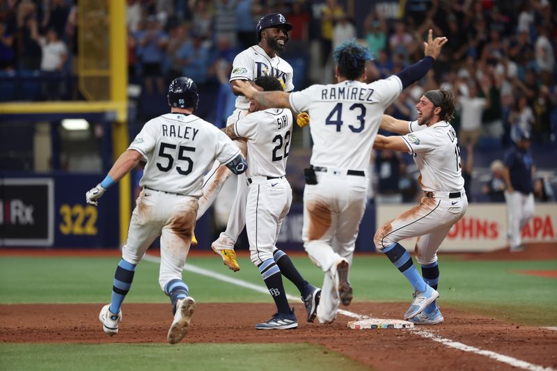 Aug 12, 2023; St. Petersburg, Florida, USA;  Tampa Bay Rays left fielder Randy Arozarena (56) is congratulated after he hit a walk off RBI single against the Cleveland Guardians during the ninth inning at Tropicana Field. Mandatory Credit: Kim Klement Neitzel-USA TODAY Sports