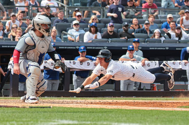 Aug 4, 2024; Bronx, New York, USA;  New York Yankees shortstop Anthony Volpe (11) scores a run on an RBI by third baseman DJ LeMahieu (26) sacrifice fly during the sixth inning against the Toronto Blue Jays at Yankee Stadium. Mandatory Credit: Vincent Carchietta-USA TODAY Sports