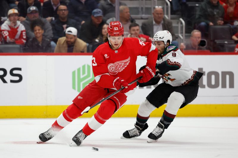 Mar 14, 2024; Detroit, Michigan, USA;  Detroit Red Wings defenseman Moritz Seider (53) skates with the puck chased by Arizona Coyotes center Nick Schmaltz (8) in the first period at Little Caesars Arena. Mandatory Credit: Rick Osentoski-USA TODAY Sports