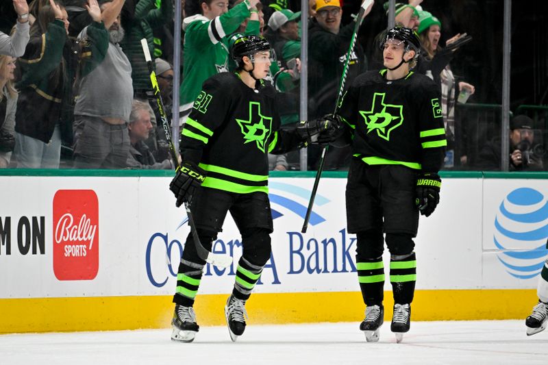 Jan 10, 2024; Dallas, Texas, USA; Dallas Stars left wing Jason Robertson (21) and center Roope Hintz (24) celebrates a goal scored by Robertson against the Minnesota Wild during the third period at the American Airlines Center. Mandatory Credit: Jerome Miron-USA TODAY Sports