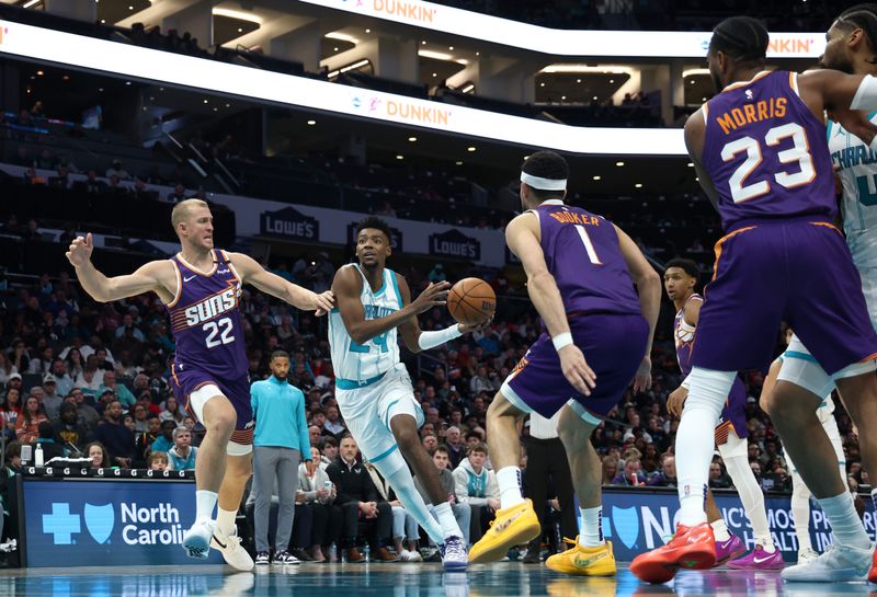 CHARLOTTE, NORTH CAROLINA - JANUARY 07: Brandon Miller #24 of the Charlotte Hornets drives to the basket against Mason Plumlee #22 of the Phoenix Suns during the second half of the game at Spectrum Center on January 07, 2025 in Charlotte, North Carolina. NOTE TO USER: User expressly acknowledges and agrees that, by downloading and or using this photograph, User is consenting to the terms and conditions of the Getty Images License Agreement. (Photo by Jared C. Tilton/Getty Images)