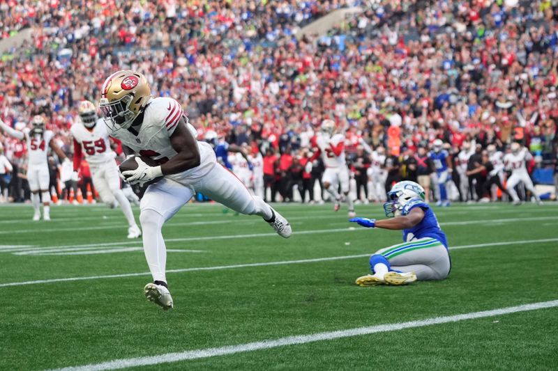 San Francisco 49ers safety Malik Mustapha makes an interception during the first half of an NFL football game against the Seattle Seahawks, Thursday, Oct. 10, 2024, in Seattle. (AP Photo/Lindsey Wasson)