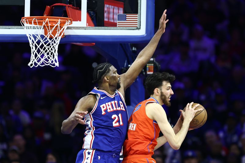 PHILADELPHIA, PENNSYLVANIA - APRIL 02: Joel Embiid #21 of the Philadelphia 76ers guards Chet Holmgren #7 of the Oklahoma City Thunder during the third quarter at the Wells Fargo Center on April 02, 2024 in Philadelphia, Pennsylvania. NOTE TO USER: User expressly acknowledges and agrees that, by downloading and or using this photograph, User is consenting to the terms and conditions of the Getty Images License Agreement. (Photo by Tim Nwachukwu/Getty Images)