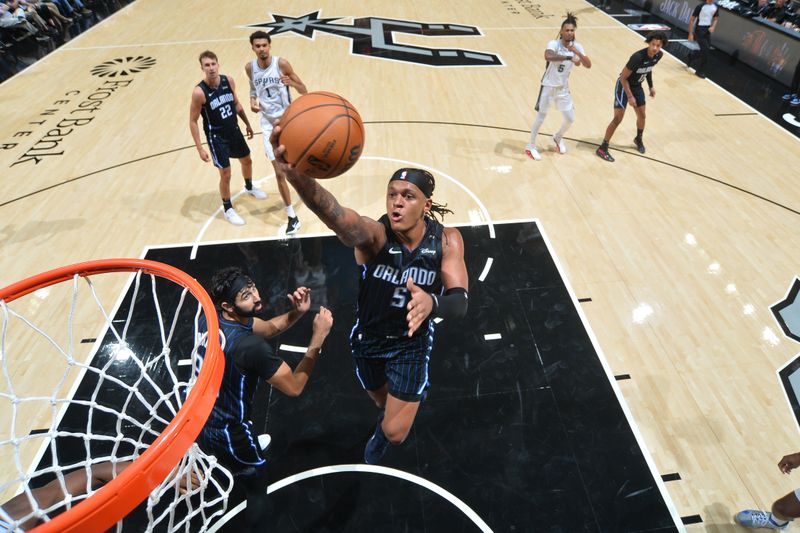 SAN ANTONIO, TX - OCTOBER 9: Paolo Banchero #5 of the Orlando Magic drives to the basket during the game against the San Antonio Spurs during a NBA preseason game on October 9, 2024 at the Frost Bank Center in San Antonio, Texas. NOTE TO USER: User expressly acknowledges and agrees that, by downloading and or using this photograph, user is consenting to the terms and conditions of the Getty Images License Agreement. Mandatory Copyright Notice: Copyright 2024 NBAE (Photos by Michael Gonzales/NBAE via Getty Images)