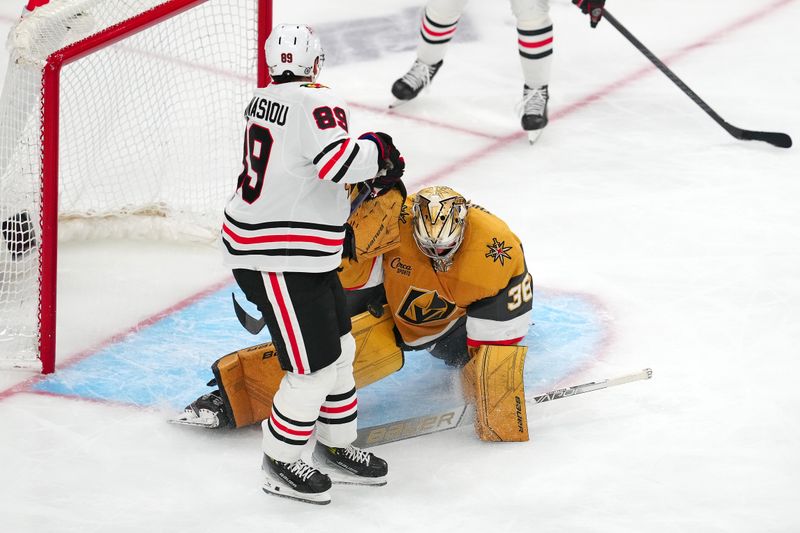 Apr 16, 2024; Las Vegas, Nevada, USA; Vegas Golden Knights goaltender Logan Thompson (36) makes a save as Chicago Blackhawks center Andreas Athanasiou (89) attempts a deflection during the third period at T-Mobile Arena. Mandatory Credit: Stephen R. Sylvanie-USA TODAY Sports