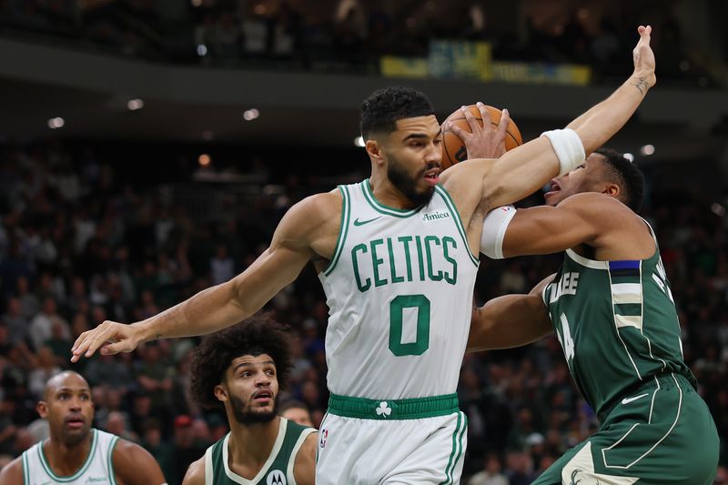 MILWAUKEE, WISCONSIN - NOVEMBER 10: Giannis Antetokounmpo #34 of the Milwaukee Bucks is fouled by Jayson Tatum #0 of the Boston Celtics during the first half of a game at Fiserv Forum on November 10, 2024 in Milwaukee, Wisconsin. NOTE TO USER: User expressly acknowledges and agrees that, by downloading and or using this photograph, User is consenting to the terms and conditions of the Getty Images License Agreement. (Photo by Stacy Revere/Getty Images)