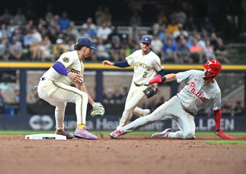 Sep 16, 2024; Milwaukee, Wisconsin, USA;  Milwaukee Brewers shortstop Willy Adames (27) tags out Philadelphia Phillies shortstop Trea Turner (7) in the third inning at American Family Field. Mandatory Credit: Michael McLoone-Imagn Images