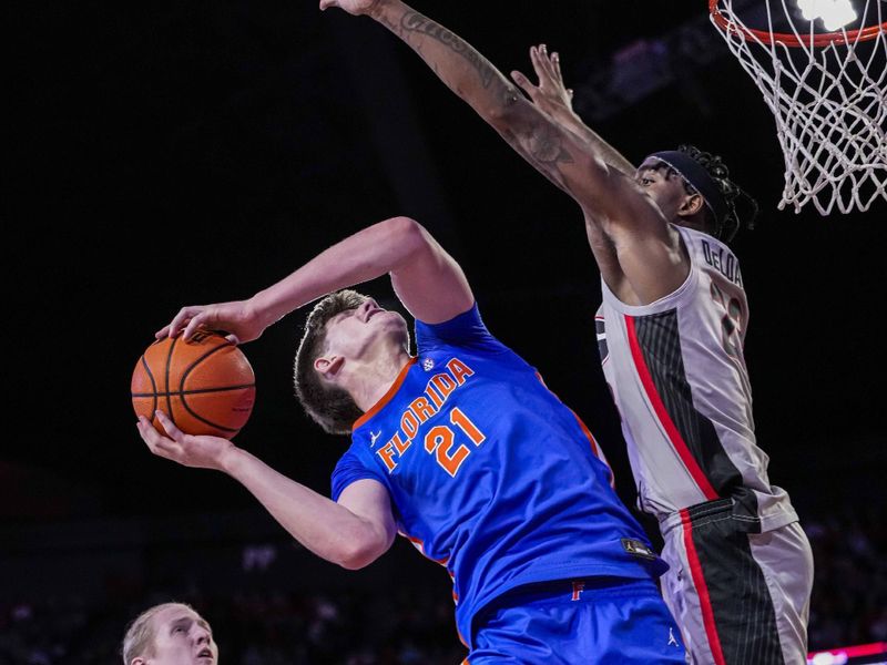 Feb 17, 2024; Athens, Georgia, USA; Florida Gators forward Alex Condon (21) tries to shoot over Georgia Bulldogs forward Jalen DeLoach (23) during the second half at Stegeman Coliseum. Mandatory Credit: Dale Zanine-USA TODAY Sports