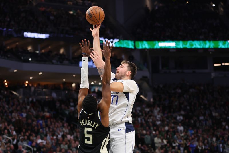 MILWAUKEE, WISCONSIN - NOVEMBER 18: Luka Doncic #77 of the Dallas Mavericks shoots over Malik Beasley #5 of the Milwaukee Bucks during the second half of a game at Fiserv Forum on November 18, 2023 in Milwaukee, Wisconsin. NOTE TO USER: User expressly acknowledges and agrees that, by downloading and or using this photograph, User is consenting to the terms and conditions of the Getty Images License Agreement. (Photo by Stacy Revere/Getty Images)